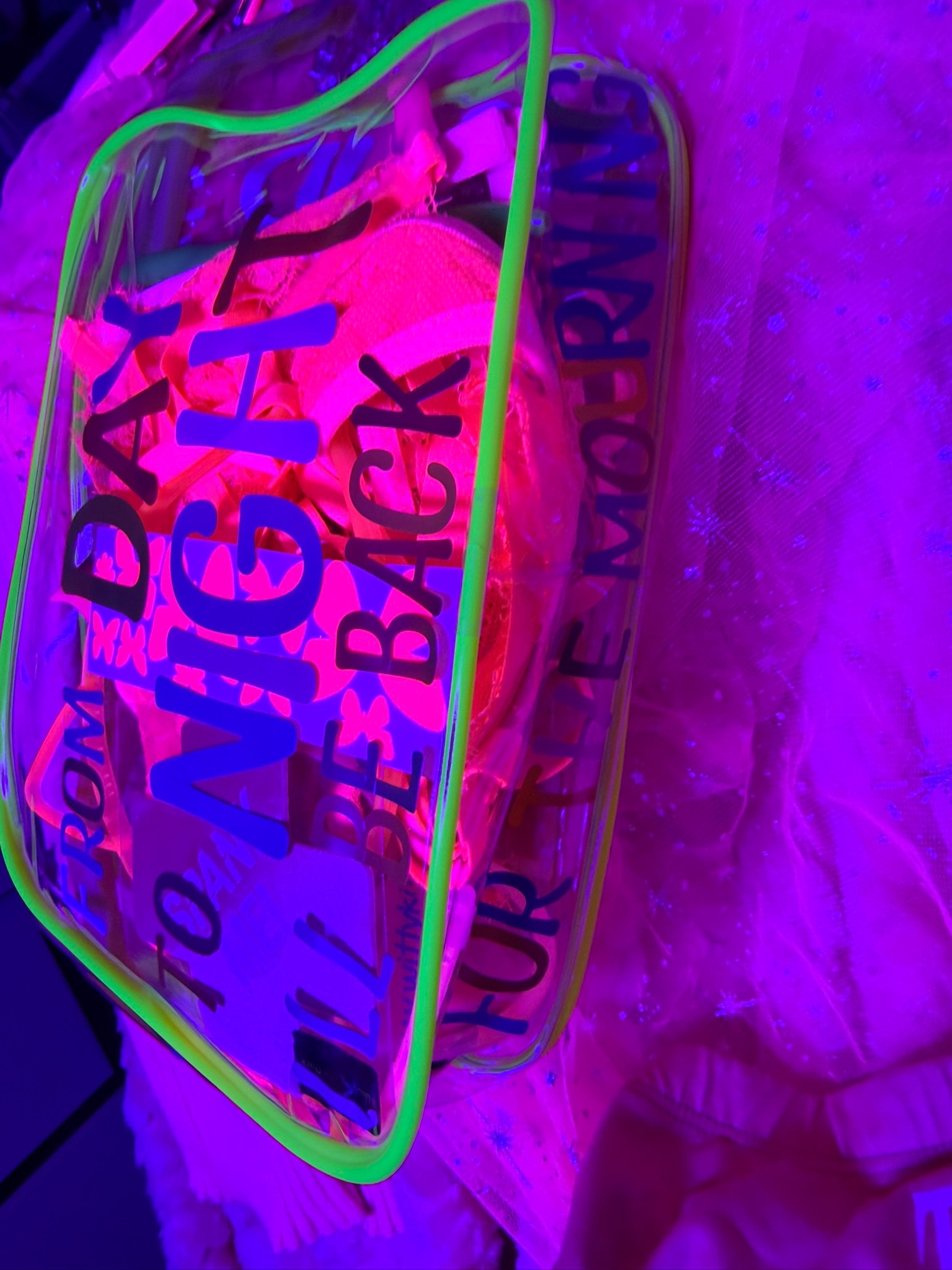 Neon sign glowing pink green purple