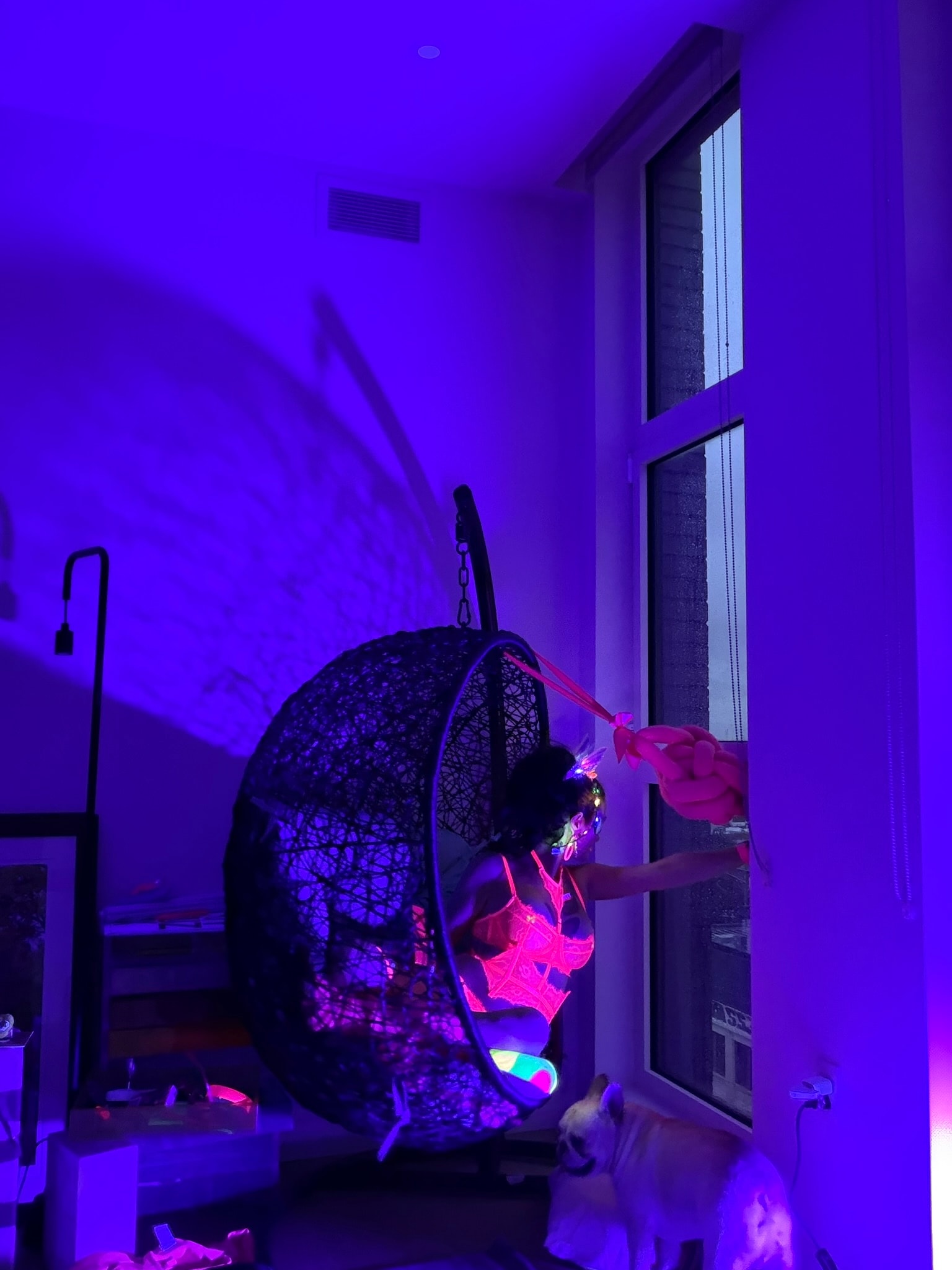 Neon lit room with glowing fan installation